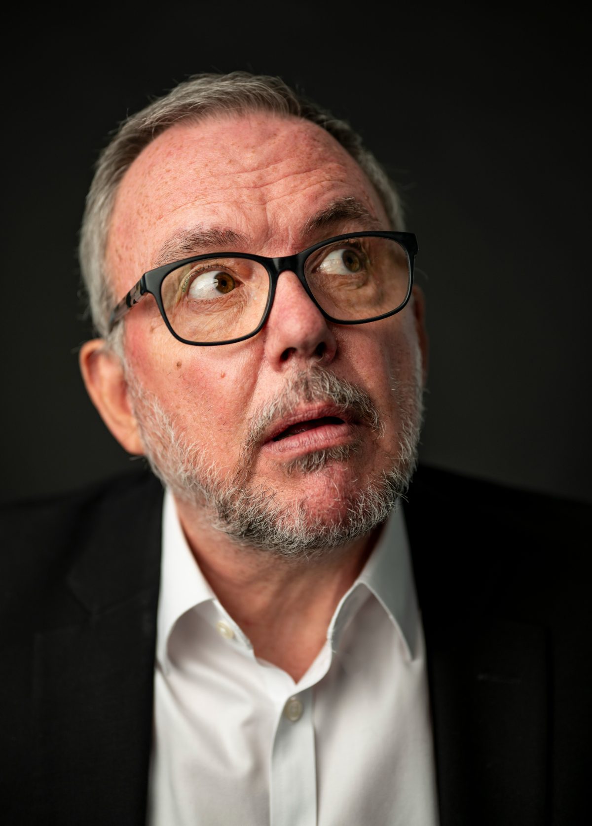 Charlie Lark in glasses, looking upward